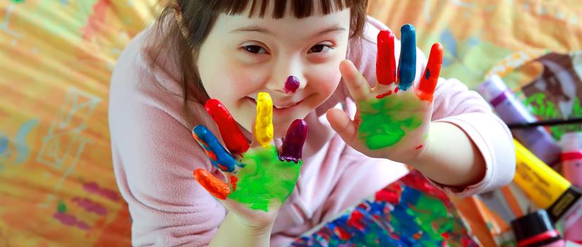 Child with special needs finger painting