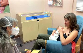 Mom feeding baby during counseling appointment