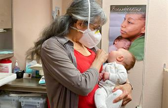 WIC staff holding baby