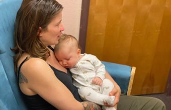 Baby sleeping in mother's arms